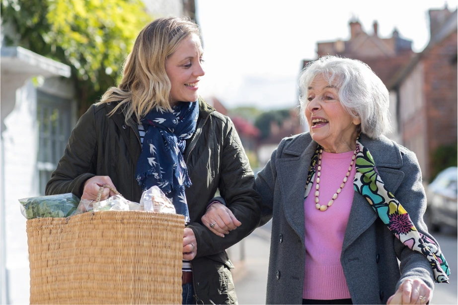 Carer supporting an older woman through EnMove independent living support