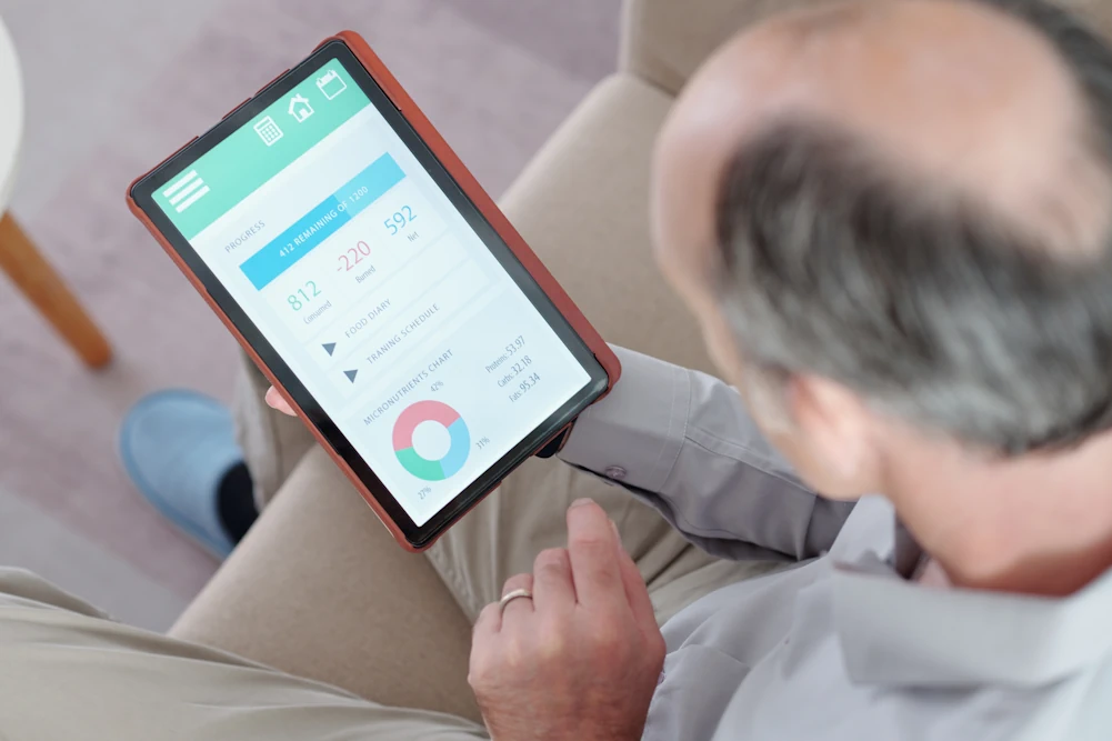Older adult using a tablet for Senecon healthy ageing support